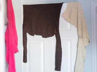 wet clothes are shown drying on a door in an apartment