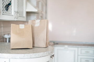 two paper packages with food delivered to home