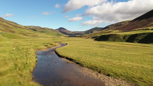 Flying along the river at the beautiful Spittal of Glenshee - The Highlands of Scotland from above - 4K Drone Movie