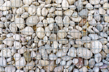 Texture background stones under the metal grid. Natural pattern. High quality photo