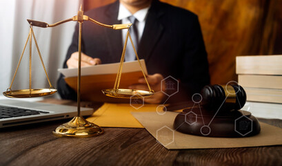Justice and law concept.Male judge in a courtroom with the gavel, working with, computer and...