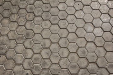 the road is paved with hexagonal paving tiles.