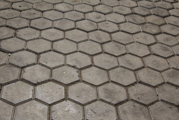 the road is paved with hexagonal paving tiles.