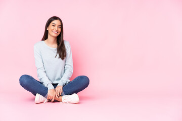 Young caucasian woman isolated on pink background laughing