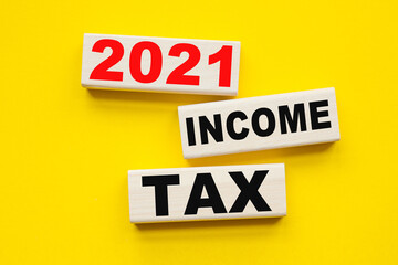 words INCOME TAX 2021 written on cubes . You can use in business, marketing and other concepts.