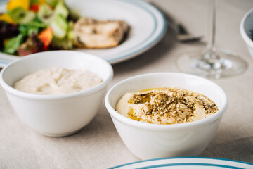 Hummus and baba ghanoush on the kitchen table. Close up