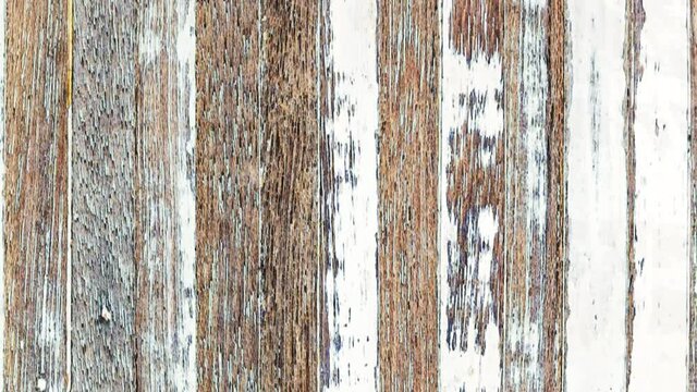 4K Seamless looping motion fast moving background from grunge weathered old wooden planks Texture. Natural aging outdoors under the sun and rain. Vertically oriented moving from top to bottom video.
