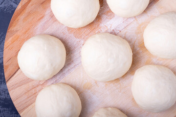 Fototapeta na wymiar Yeast dough balls on the wooden board