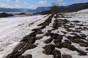 Thawing snow in fields near Muthmannsdorf in Lower Austria, Austria, Europe
