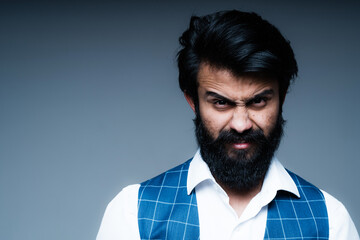 Obraz premium A man stands against a dark background showing anger and irritation. Human emotions