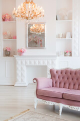 Fototapeta premium Luxury rich living room interior design with elegant classic furniture and wall decorations. Large light white room with big window and fireplace.