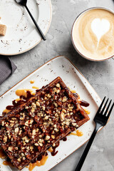 large waffles with filling on a gray background with coffee