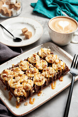 large waffles with filling on a gray background with coffee