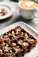 large waffles with filling on a gray background with coffee