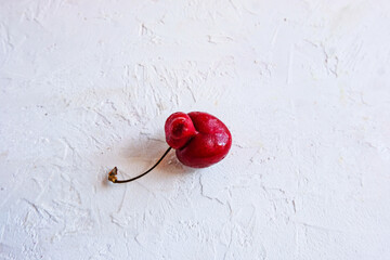 Trendy ugly organic fruits - berrie of sweet cherry on the table with copy space for text....