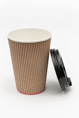 one cardboard cup for coffee and lid on a white background
