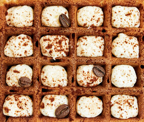 large waffles with filling on a gray background with coffee