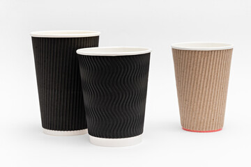 three empty cardboard cups for coffee on a white background