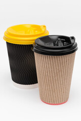 two cardboard cups with lids for coffee on a white background