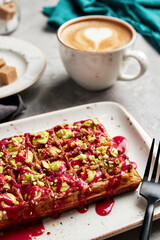 large waffles with filling on a gray background with coffee
