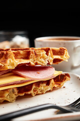 large waffles with filling on a gray background with coffee
