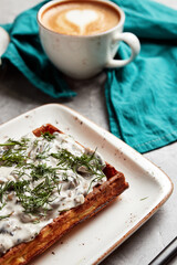 large waffles with filling on a gray background with coffee