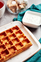 large waffles with filling on a gray background with coffee