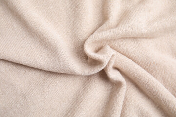 Warm cashmere sweater as background, top view