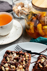 large waffles with filling on a gray background with coffee