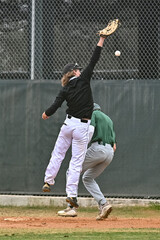 Action photo of high school baseball players making amazing plays during a baseball game