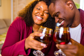 Authentic people african american couple in love drinking wine from glasses and eating italian...