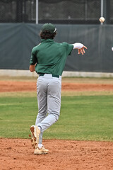 Action photo of high school baseball players making amazing plays during a baseball game