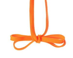 Orange shoe lace tied in bow isolated on white