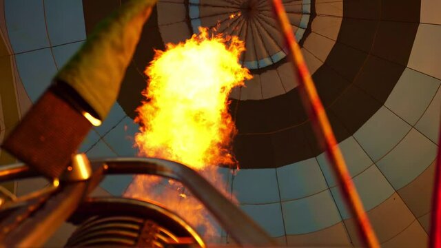 Hot Air Balloon Inflating. Hot Air Balloon fire flame. Hot air from a gas burner fills the dome of the balloon.
