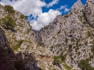 The Cares Route in the heart of Picos de Europa National Park, Cain-Poncebos, Asturias, Spain. Narrow and impressive canyon between cliffs, bridges, caves, footpaths and rocky mountains.