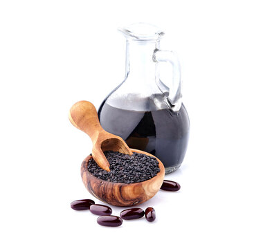 Black cumin oil pill. Nigella sativa. Nigella or Black cumin over white background.