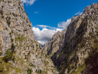 The Cares Route in the heart of Picos de Europa National Park, Cain-Poncebos, Asturias, Spain. Narrow and impressive canyon between cliffs, bridges, caves, footpaths and rocky mountains.
