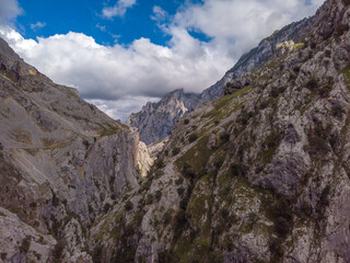 Fototapeta na wymiar The Cares Route in the heart of Picos de Europa National Park, Cain-Poncebos, Asturias, Spain. Narrow and impressive canyon between cliffs, bridges, caves, footpaths and rocky mountains.