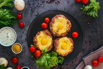 Beefsteak with egg on a plate. Delicious hot dish. The dish is decorated with cherry tomatoes and herbs. Beefsteak on a plate 