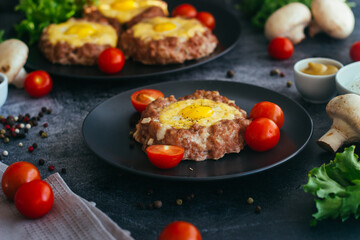 Beefsteak with egg on a plate. Delicious hot dish. The dish is decorated with cherry tomatoes and herbs. Beefsteak on a plate 