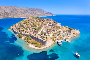 View of the island of Spinalonga with calm sea. Here were isolated lepers, humans with the Hansen's desease, gulf of Elounda, Crete, Greece.  - 411918554