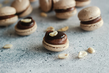 Fototapeta na wymiar Macaroons. Delicious French desserts. Macaroons with chocolate ganache. Brown macaroons on the table