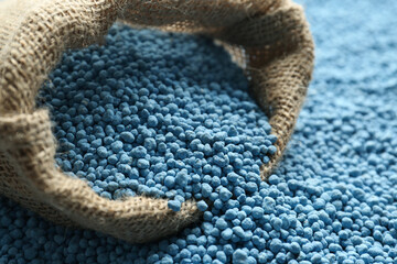 Sack bag and granular mineral fertilizer, closeup