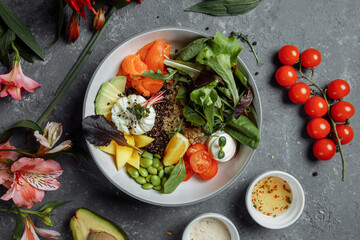 fresh healthy light breakfast, business lunch. Breakfast with poached egg, buckwheat, red fish, fresh salad, cucumbers, business lunch concept