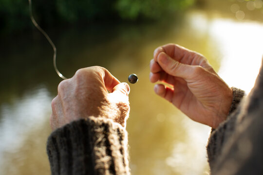 Close up man preparing weight on fly fishing line
