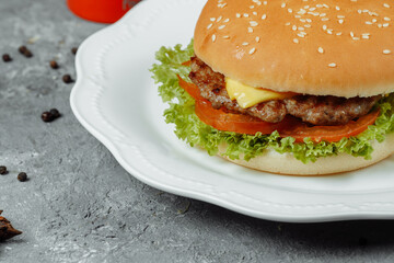 hamburger with fries and salad on the plate
