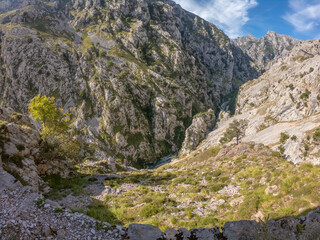 The Cares Route in the heart of Picos de Europa National Park, Cain-Poncebos, Asturias, Spain. Narrow and impressive canyon between cliffs, bridges, caves, footpaths and rocky mountains.
