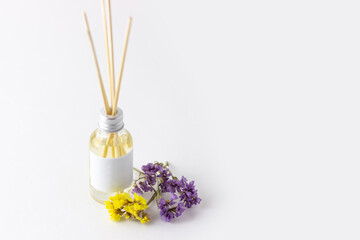 Obraz na płótnie Canvas Incense sticks for home with floral scent. Flowers and dried flowers with aroma diffuser. Eco-friendly home fragrance concept