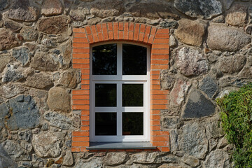 Fototapeta na wymiar Window on a stone wall.