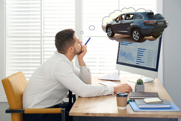 Man dreaming about new car in office